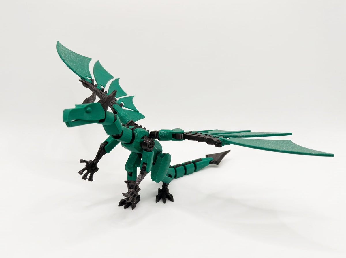 Green and black poseable dragon figure standing with wings extended and a segmented tail.