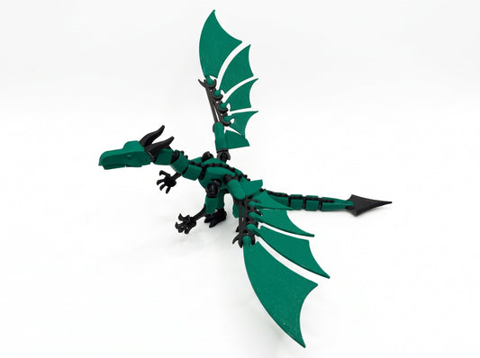 Angled view of a green and black articulated dragon figure with one wing raised.