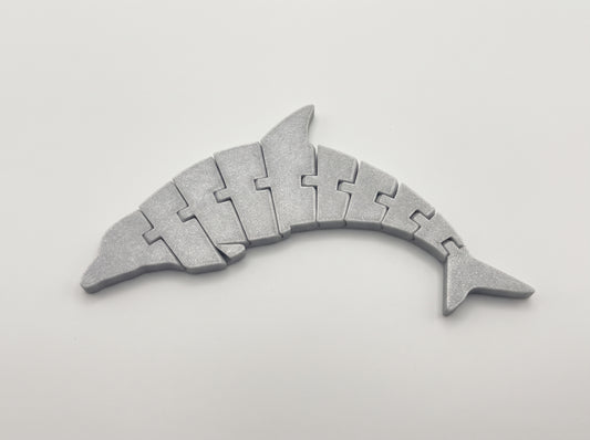 Gray articulated dolphin with a segmented body curved on a light background